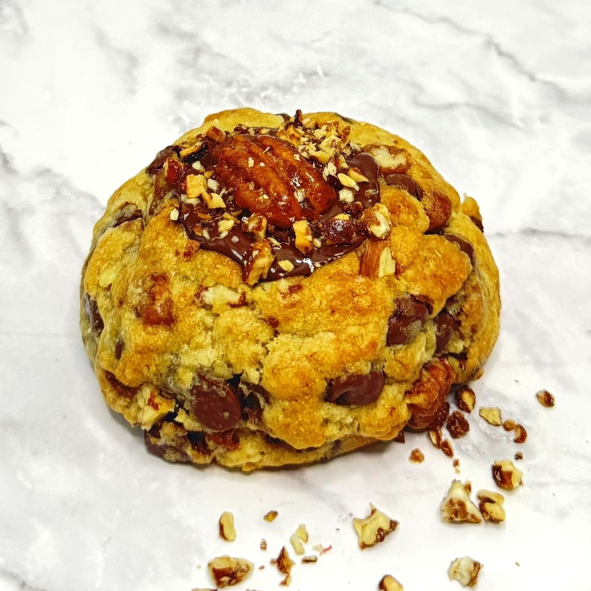 Front view of a Golden Banane Cookie with ripe banana, rich chocolate and caramelized pecans from Le Petit Cookie.