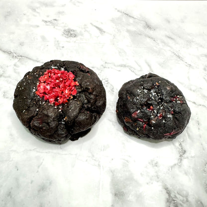 Midnight Berry Cookies: petit (3oz) next to regular (5.3oz) for size comparison on a marble countertop.