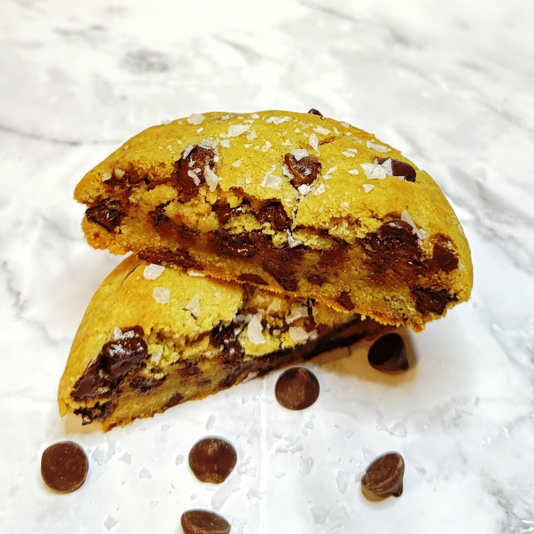 Golden Crumb cookie cut in half, showcasing the rich melty chocolate.