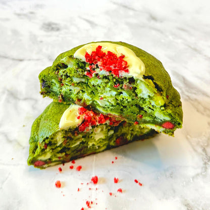 Jade Kiss cookie cut in half, showcasing creamy white chocolate and freeze dried strawberries.