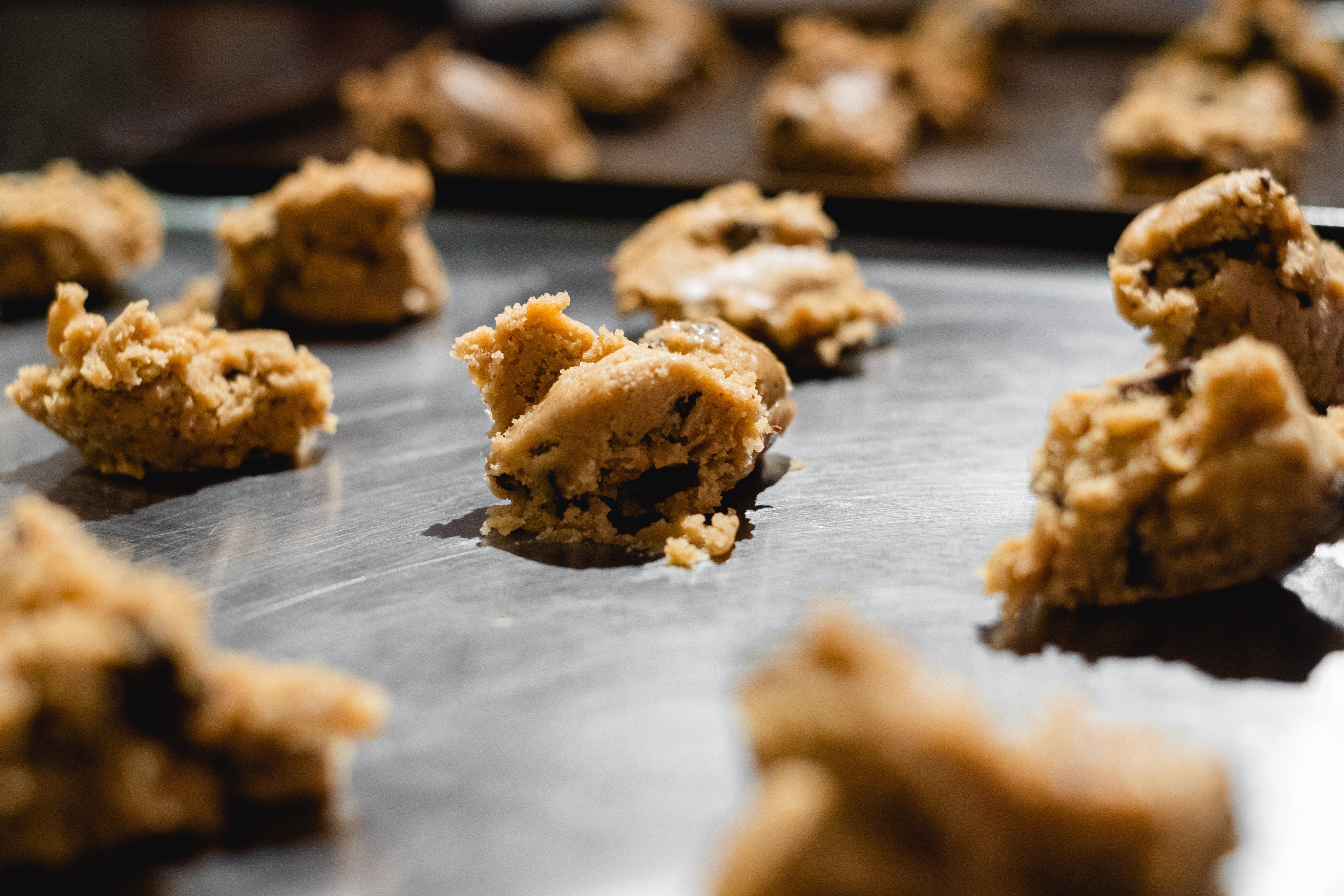 Raw cookie dough on a silver baking tray